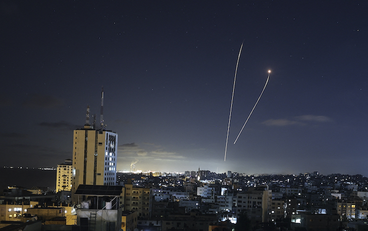A streak of light appears as Israel's Iron Dome anti-missile system intercepts rockets launched from the Gaza Strip